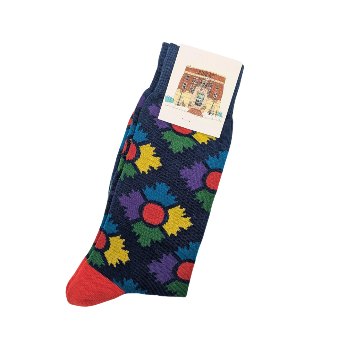 Pair of navy socks with colourful Museum icon in an argyle pattern with a red heel, folded in half lengthways and secured with a Museum branded tag at the top