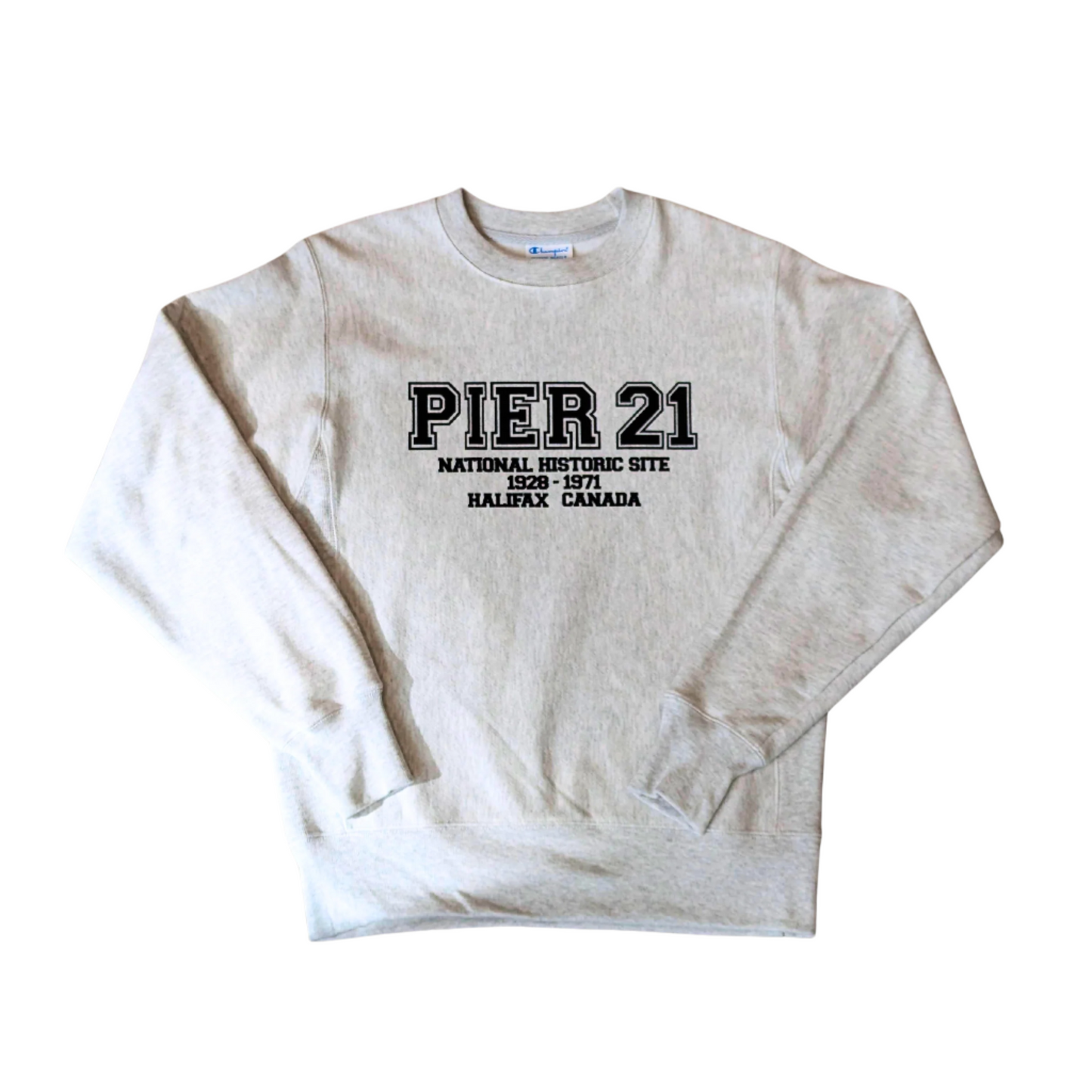 Heather grey long-sleeved sweatshirt with Pier 21 in varsity-style lettering and National History Site 1928-1971 Halifax Canada below