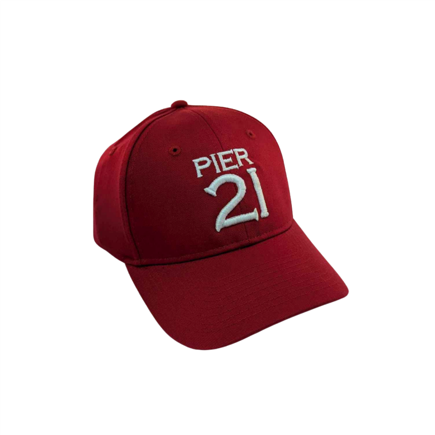 Red, dad-style baseball hat with Pier 21 embroidered on the front in white