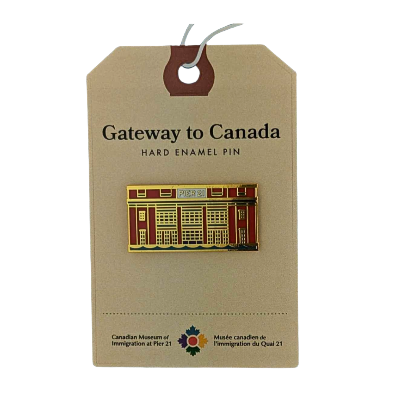 Enamel pin in the shape of the façade of Pier 21 in orange, navy, teal and gold on a backing card that has Gateway to Canada at the top and the museum's logo on the bottom