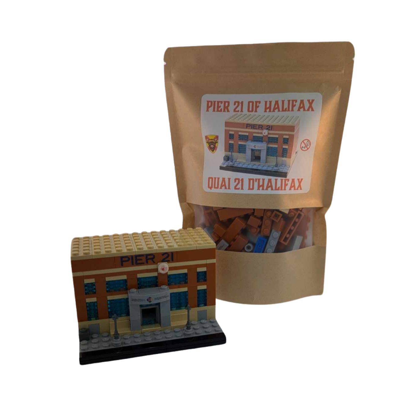 Completed brick building in front of a brick kit in brown paper bag. 