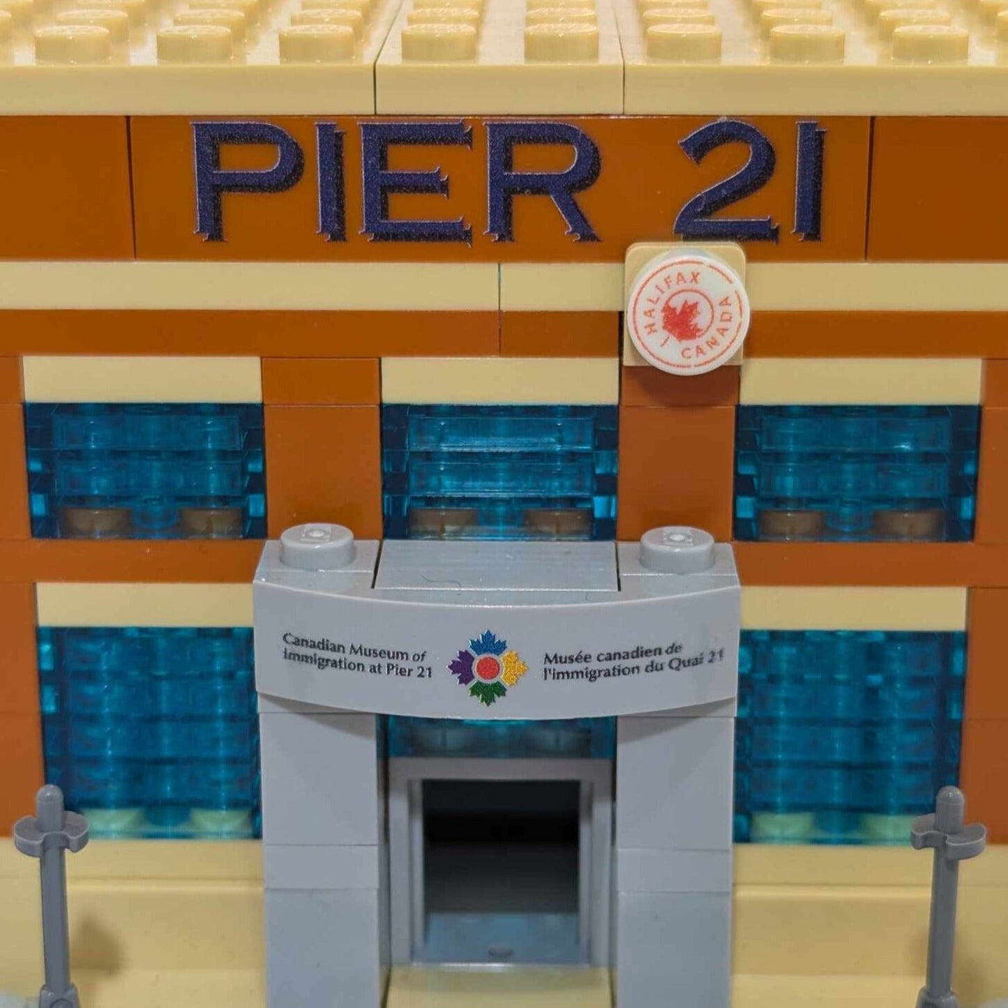 Close up of Pier 21 and Canadian Museum of Immigration at Pier 21 signs on brick model of pier