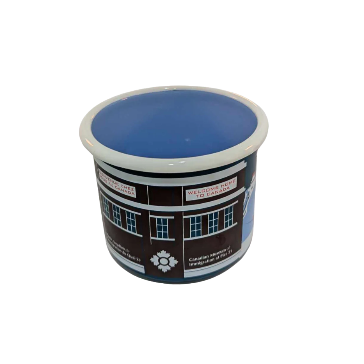 Center view of enamel mug with artistic representation of a ship docked outside Pier 21 in blues, brown and red 