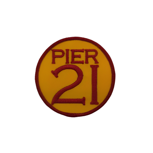 Round golden-yellow patch with deep embroidery, Pier 21 