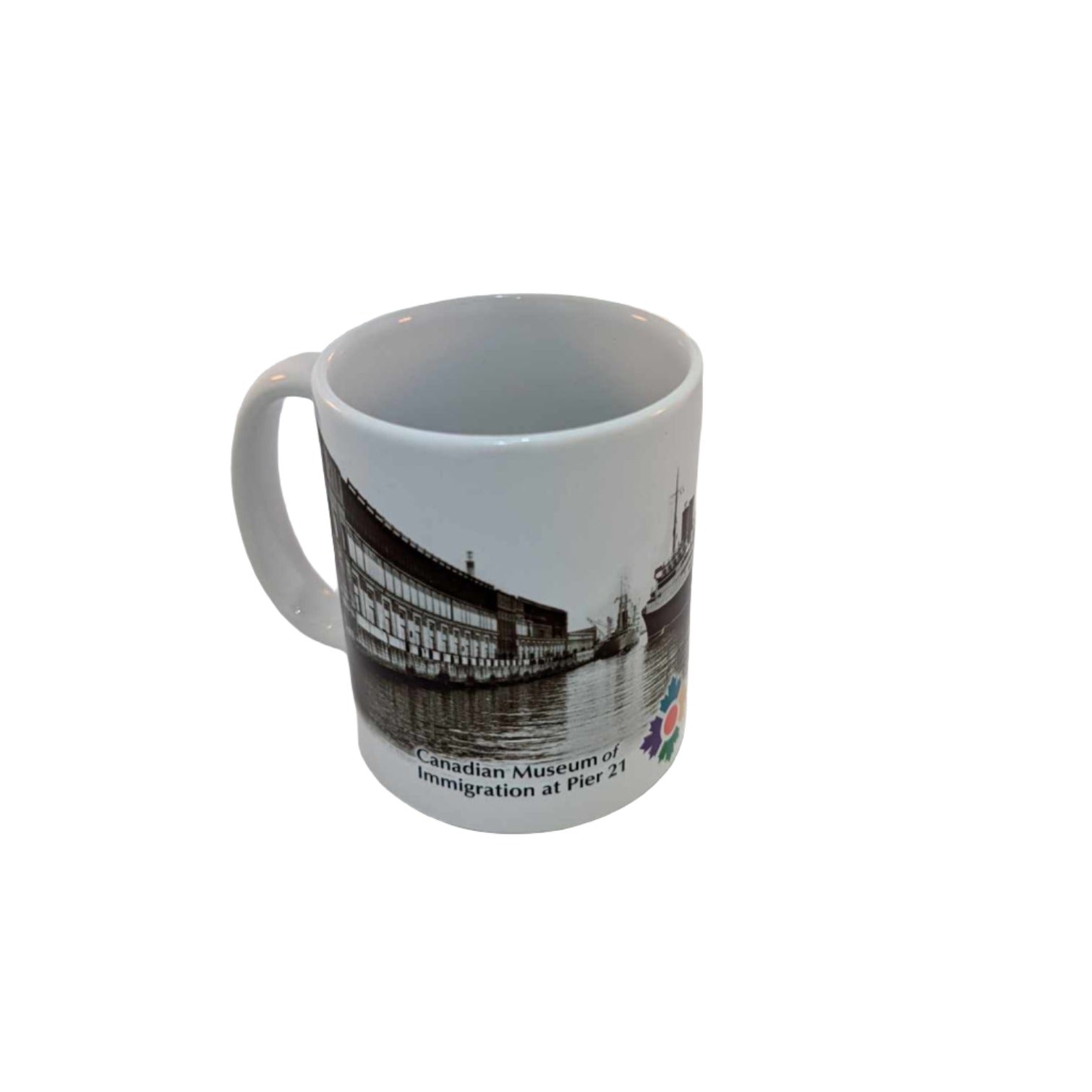 White mug with left side of image of Berlin II docking at Pier 21 and Museum's logo 