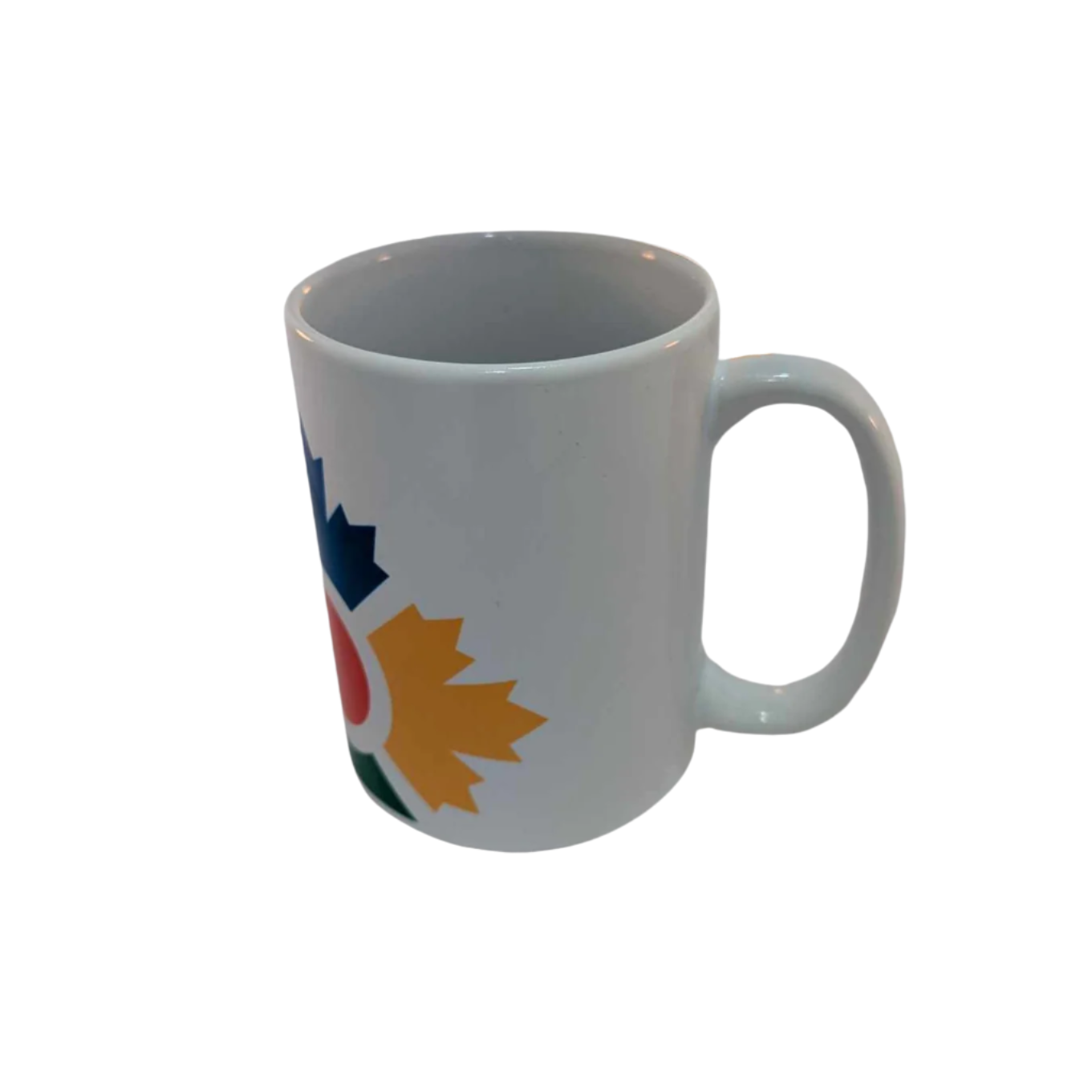 Right side of tall, white mug with partial image of colourful icon with blue, yellow and green maple leaves shown and the red circle in the middle 