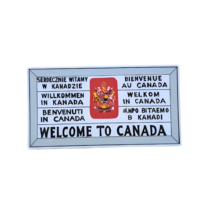 Historic sign that says 'Welcome to Canada' in seven languages and features a red crest in the middle 