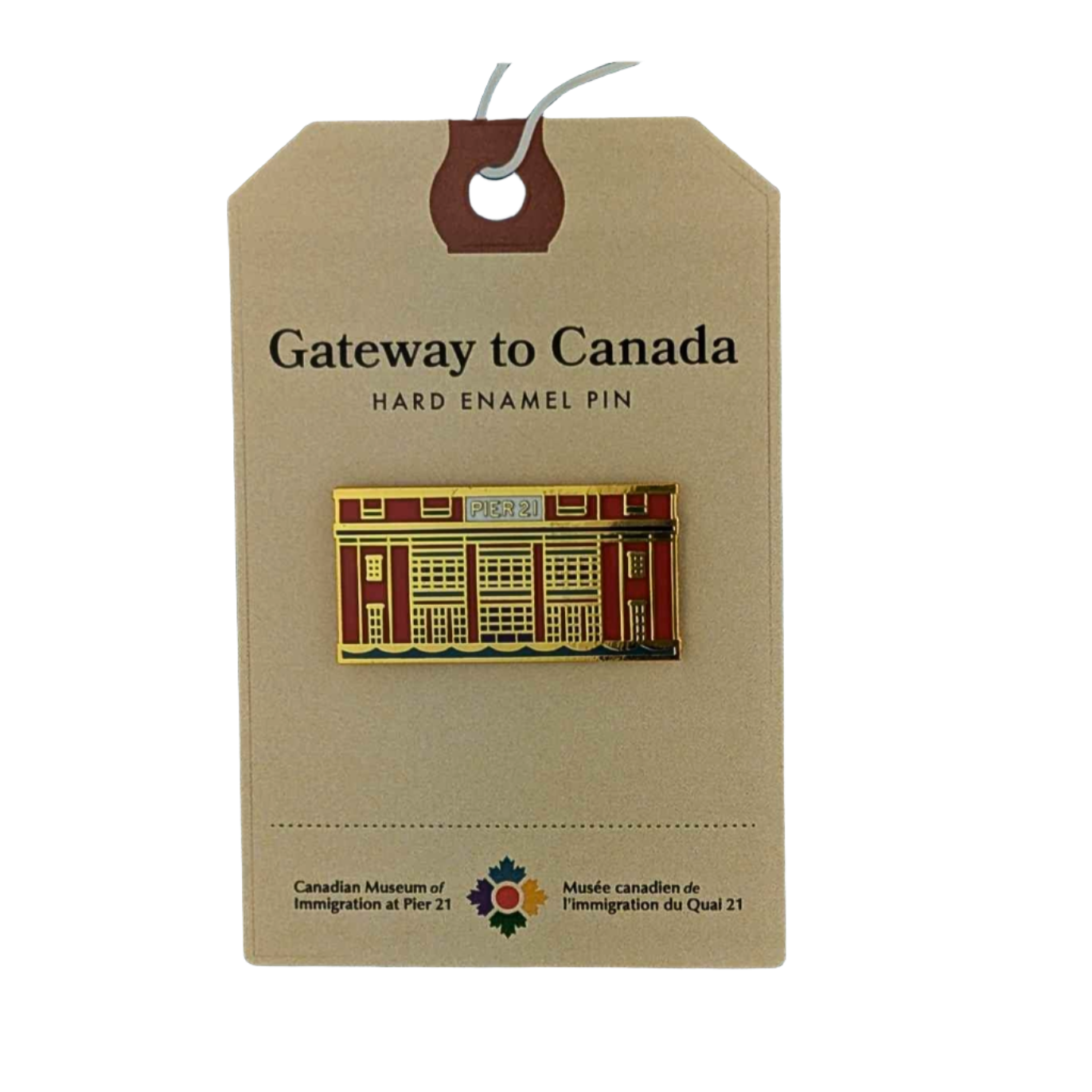 Enamel pin in the shape of the façade of Pier 21 in orange, navy, teal and gold on a backing card that has Gateway to Canada at the top and the museum's logo on the bottom 