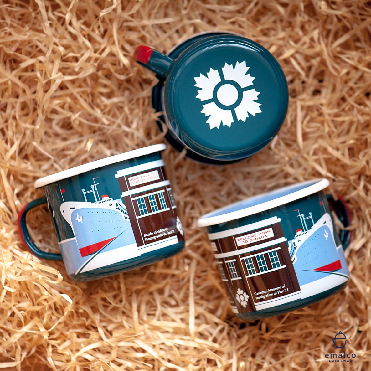 Three views of a teal coloured metal mug featuring an ocean liner, the Immigration Shed and the Museum logo.